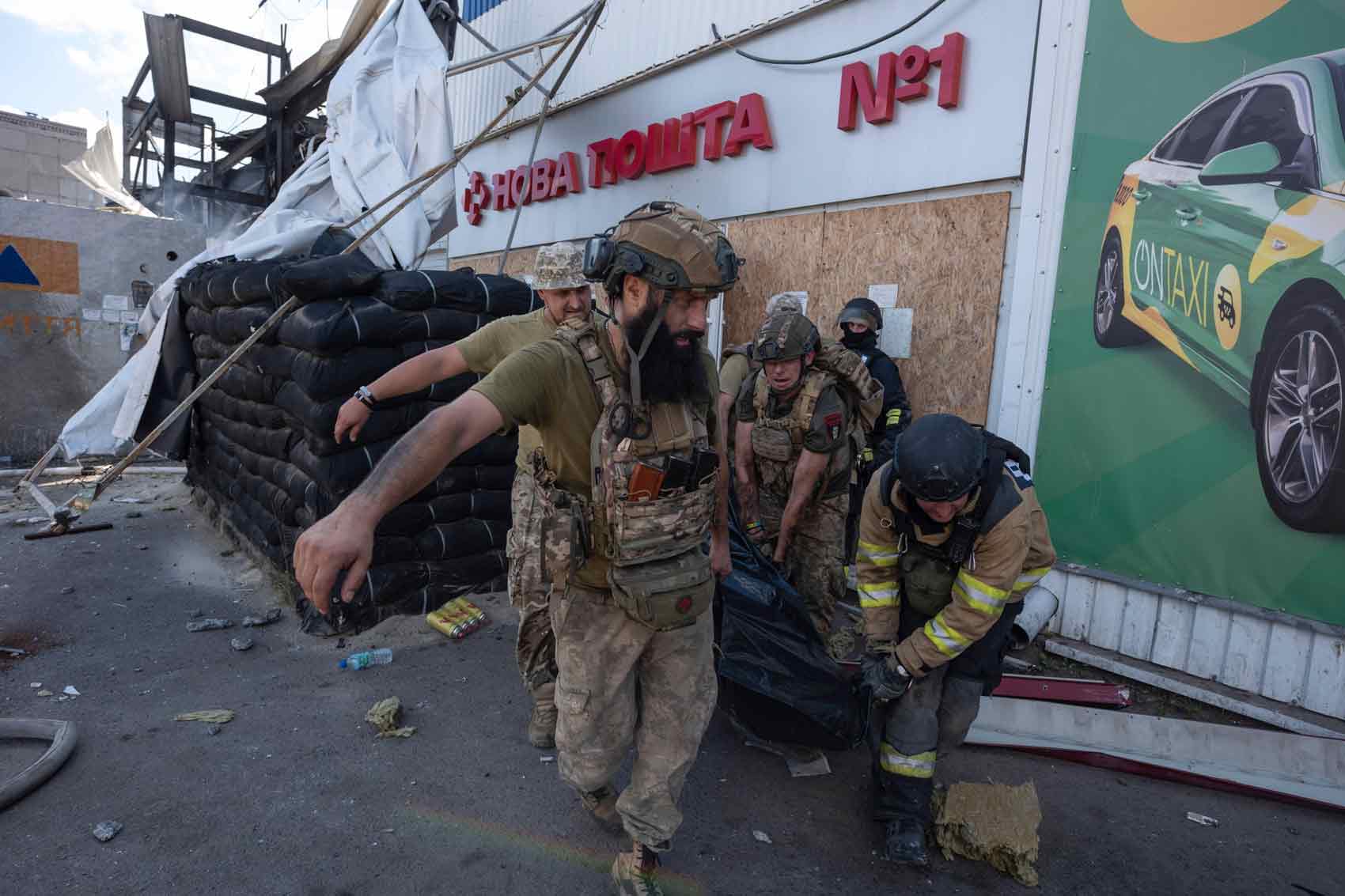 Ukrainian emergency workers after Russia strike.